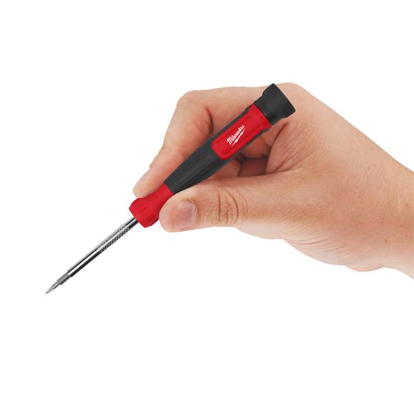 Hand holding Milwaukee 4 in 1 Precision Multi-Bit Screwdriver with visible red and black handle and metal shaft.