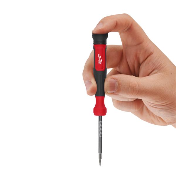 Hand holding Milwaukee 4 in 1 Precision Multi-Bit Screwdriver with red and black handle and metal shaft.