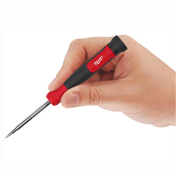 Hand holding a Milwaukee 14 in 1 multi-bit screwdriver with red and black handle and extended bit.