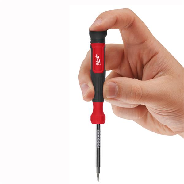 Hand holding Milwaukee 14 in 1 Multi-Bit Screwdriver showing red and black handle and extended bit.