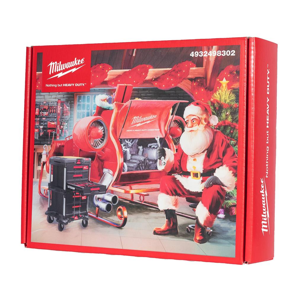Milwaukee Christmas Promo Box with Santa repairing a red sleigh and a black tool cart in a workshop setting
