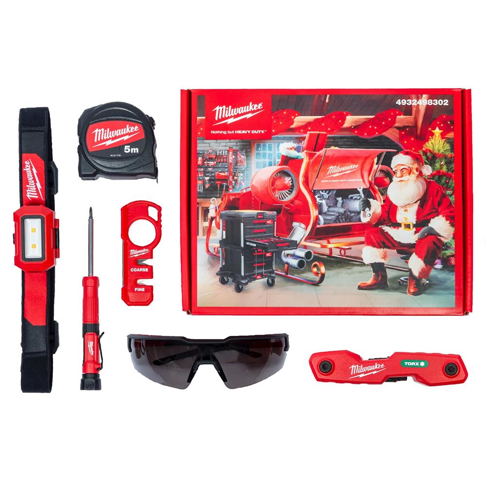 Milwaukee Christmas Promo Box with tape measure, screwdriver, safety glasses, light, and tool accessories on white