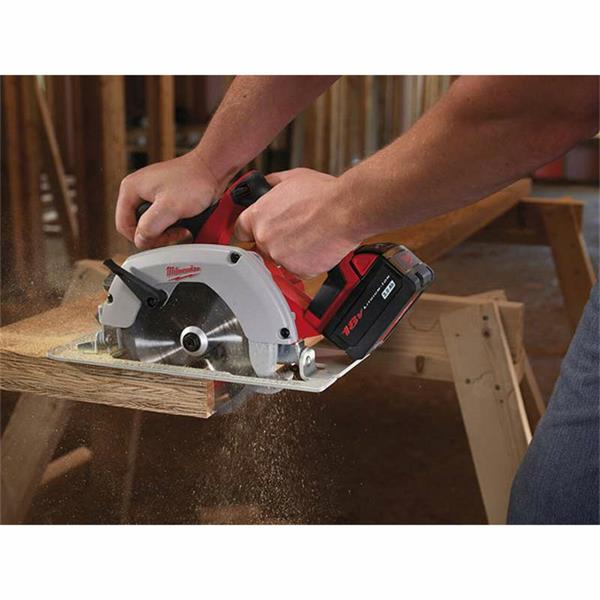 Hands operating a Milwaukee 18V circular saw cutting through a wooden board on a workbench.