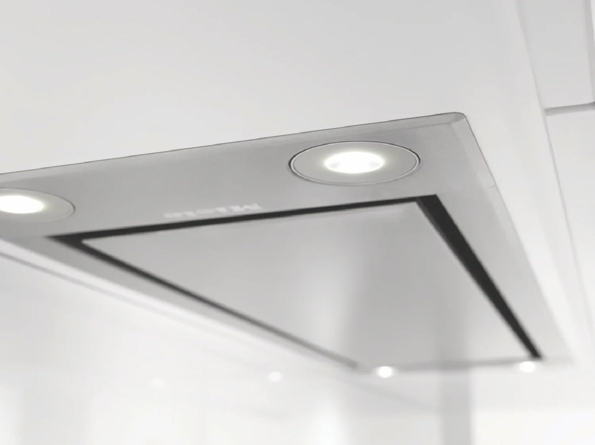 Close-up of the stainless steel Miele DA 2698 88cm integrated cooker hood with built-in lights installed under a white