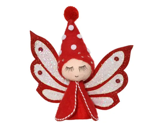 A red and white felt fairy ornament with glittery wings, a red pointed hat with white polka dots, and a beige fabric face, shown on a plain white background.