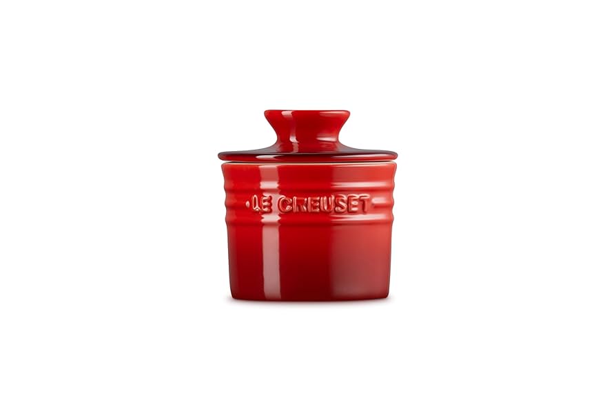 Le Creuset Butter Crock in cerise red with lid, shown front view on white background.