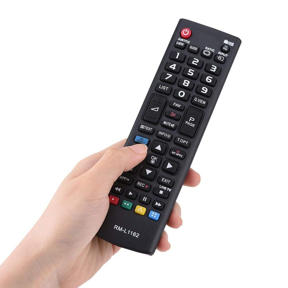 Hand holding a LG black remote control with various buttons on a white background
