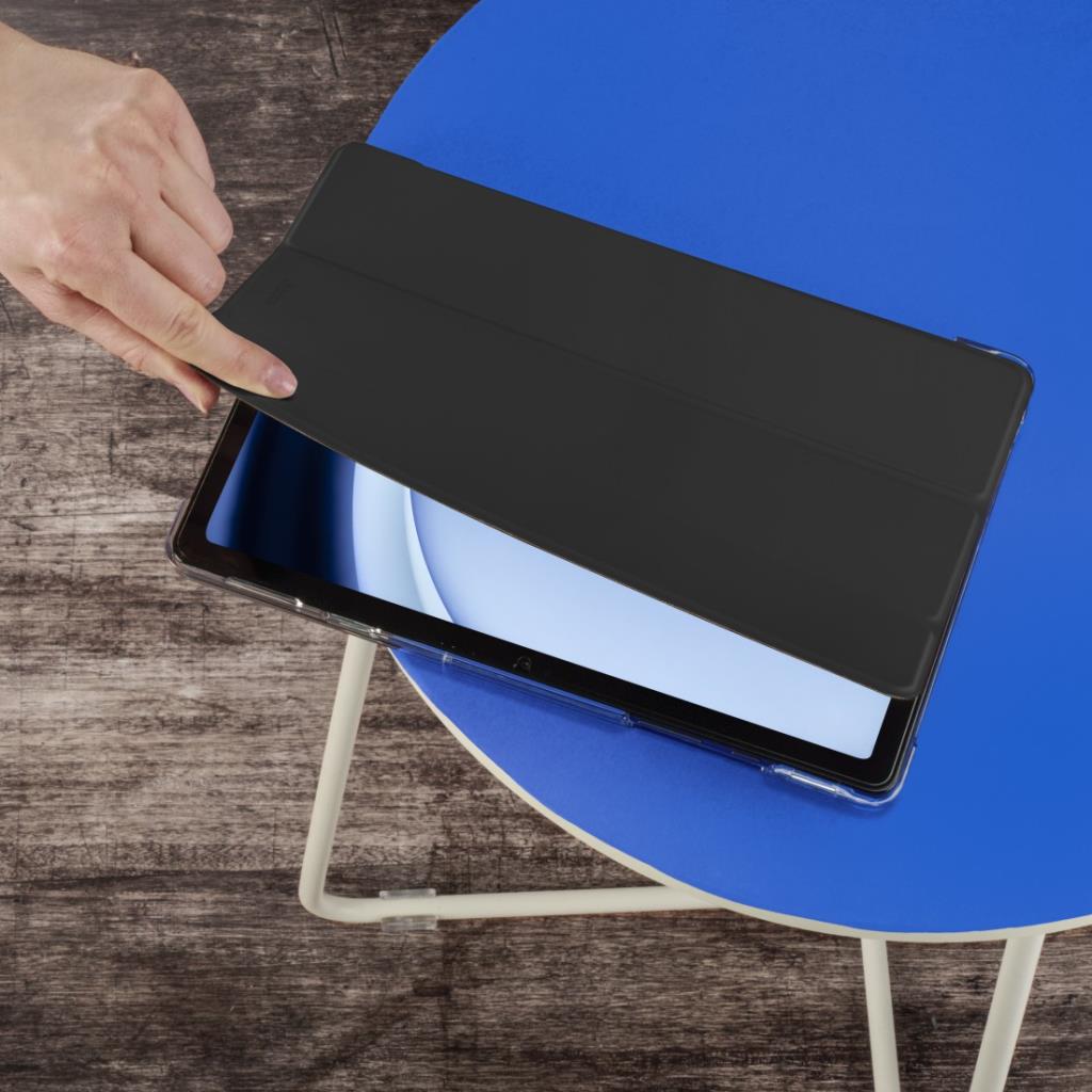 Hand lifting the black cover of a Hama Samsung A11 8.7" case on a blue table.