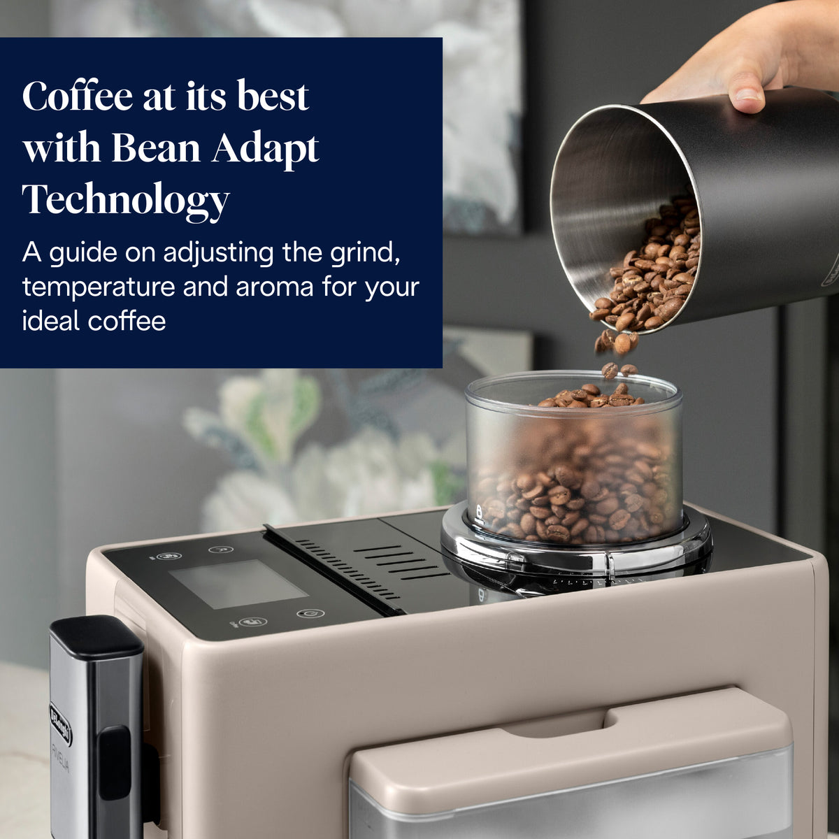 Close-up of cream DeLonghi Rivelia coffee machine bean hopper with coffee beans being poured in.