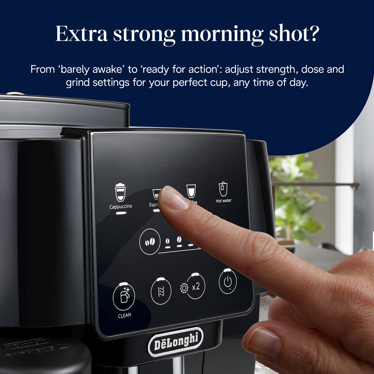 Finger pressing espresso button on the touchscreen of DeLonghi Magnifica Start coffee machine in black.