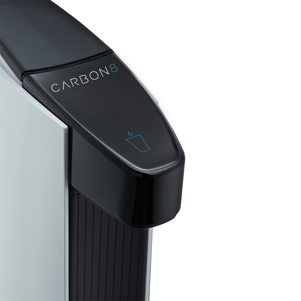 Close-up of the Carbon8 One Touch Sparkling Water Dispenser's black top with logo and water glass icon.