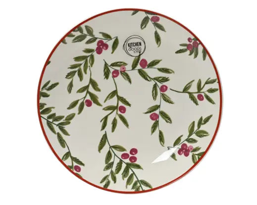 A round ceramic plate with a white background, decorated with green leafy vines and small pink berries, finished with a thin red rim. A small circular logo for 'KITCHEN' is printed near the top center.
