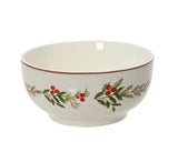 A white ceramic bowl featuring a green and red holly leaf and berry pattern around the lower half, with a thin red inner rim, shown against a plain white background.