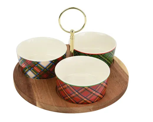 A three-tiered ceramic serving tray with a round wooden base, gold-tone metal ring handle, and bowls decorated in red, green, blue, and white tartan plaid patterns, shown on a white background.