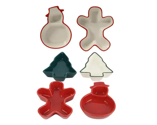 Six ceramic holiday-shaped dishes in red, green, and white, including snowman, gingerbread man, Christmas tree, and Christmas tree-with-out-tree-stand shapes, arranged on a white background.