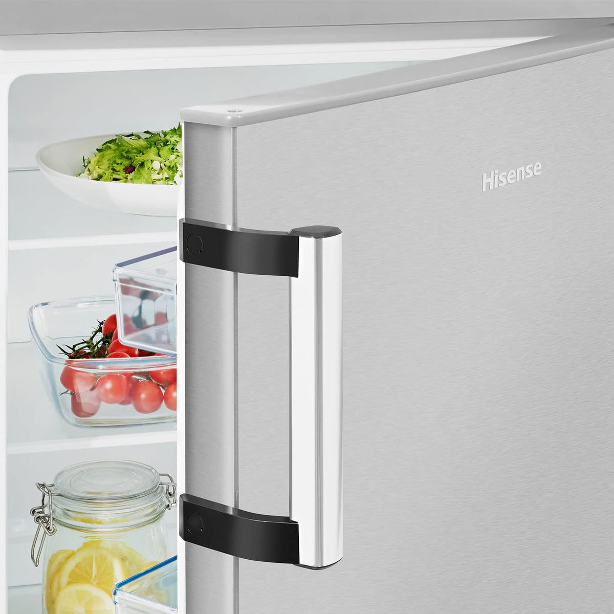 Close-up of Hisense 56cm undercounter fridge door handle and partially open interior with fresh food inside.