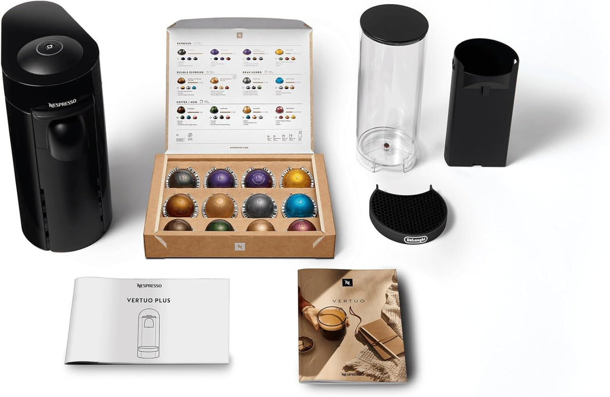 Delonghi Nespresso Vertuo Plus coffee machine with capsule box, water tank, drip tray, and manuals on white background