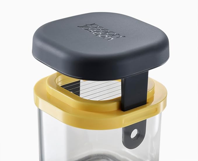 Multi Prep Mini vegetable chopper with black lid, yellow frame, and clear container shown from top angle.