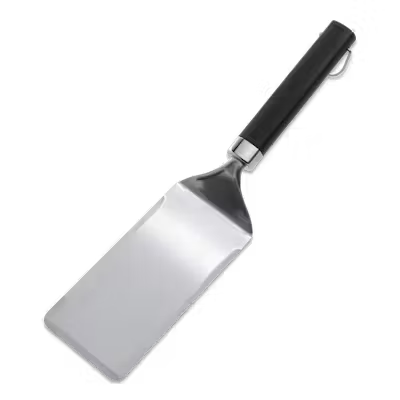 Weber Plancha Spatula with a wide, bevelled stainless steel blade and black non-slip handle against a white background.