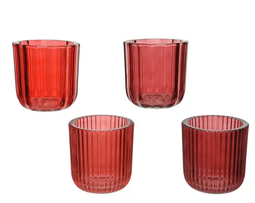 Four red glass tumblers with a ribbed texture on a white background