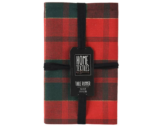 Folded rectangular cotton table runner in green and red check, tied with black ribbon and label.