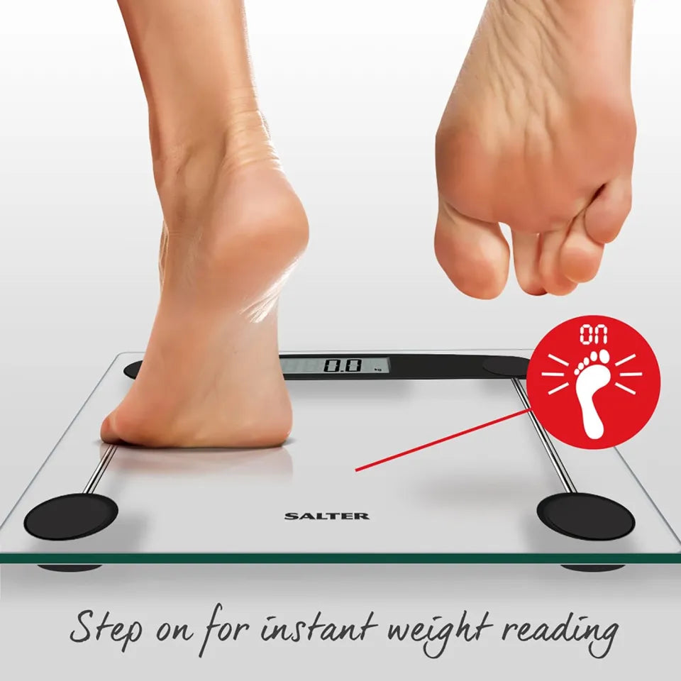 Salter Electronic Compact Bathroom Scales with a foot stepping on the glass surface and digital display showing 0.0 kg.