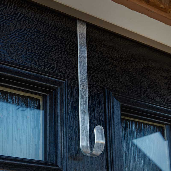 Metallic hook on a dark wooden door