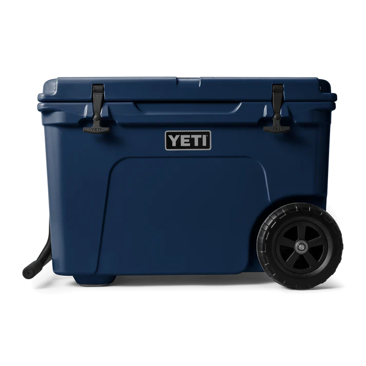 YETI Tundra Haul Navy wheeled cooler with black latches, large puncture-resistant wheel, and ToughArm handle.