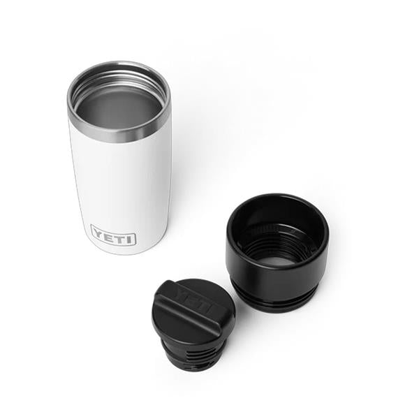 White Rambler 12oz travel bottle with two black detachable lids shown from above on white background