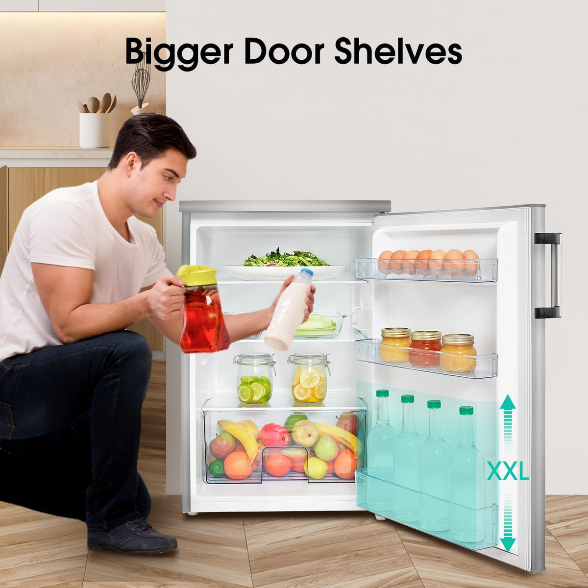 Hisense 56cm undercounter fridge open with man placing drinks inside, showing spacious shelves and fruit drawer.