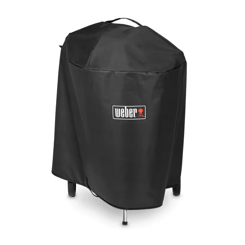 Black Weber Premium Barbecue Cover fitted on a 57cm Master-Touch grill, showing logo and top handle.