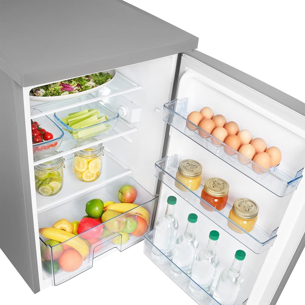 Hisense 56cm undercounter fridge open showing shelves with fruits, jars, eggs, and bottles inside