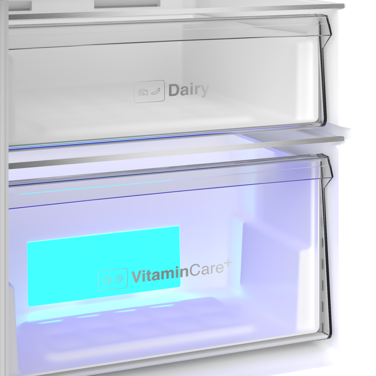 Close-up of the Blomberg fridge's transparent dairy compartment and illuminated VitaminCare+ drawer inside the white tall