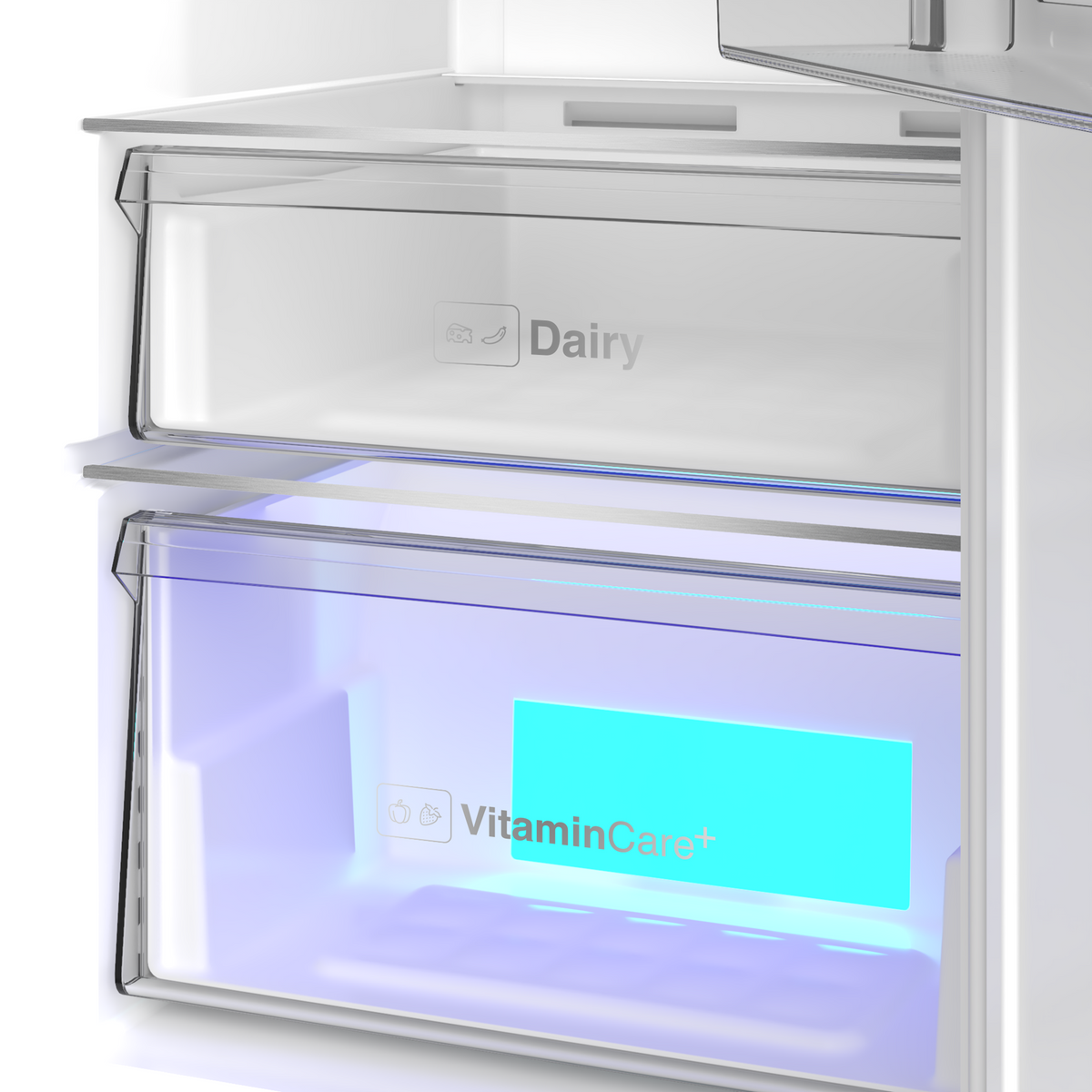 Close-up of the Blomberg tall larder fridge's clear dairy and VitaminCare+ storage drawers with interior lighting.