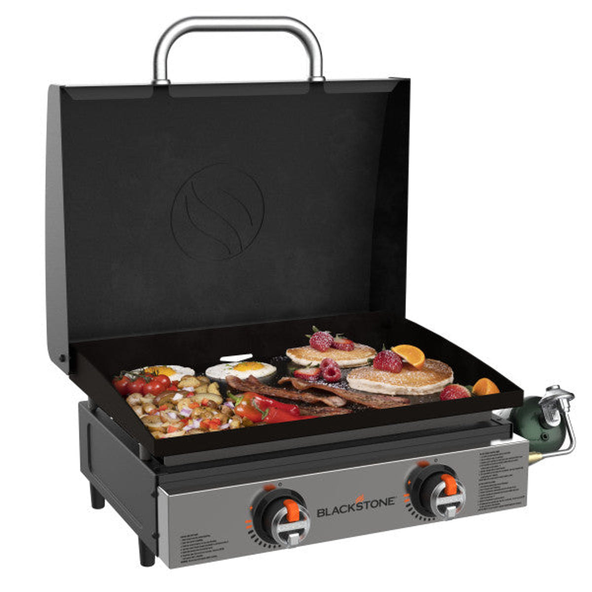Blackstone 22" tabletop griddle with hood open, cooking eggs, bacon, pancakes, and vegetables.