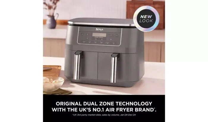 Ninja DZ300UK 6-in-1 Dual Zone Air Fryer 7.6L in dark grey with dual baskets and digital control panel on kitchen counter.