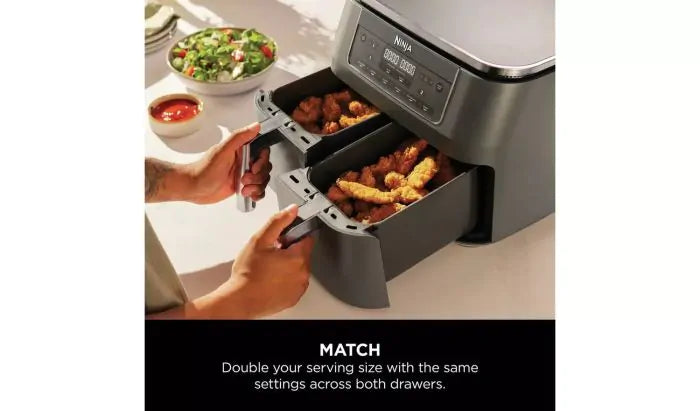 Ninja DZ300UK air fryer with both drawers open, filled with fried chicken strips and nuggets.