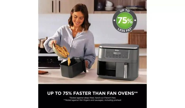 Woman removing cooked food from the Ninja DZ300UK 6-in-1 Dual Zone Air Fryer 7.6L in a kitchen setting