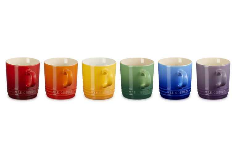Set of six Le Creuset cappuccino mugs in red, orange, yellow, green, blue, and purple, side view.