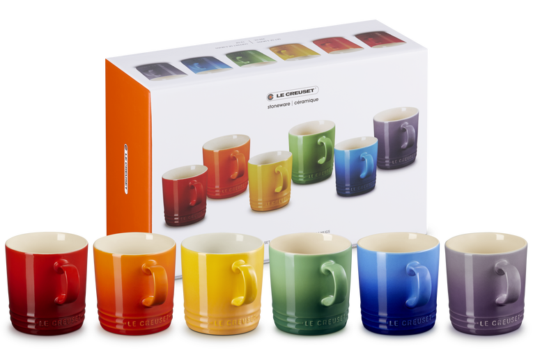 Le Creuset Rainbow Set of 6 London Mugs in red, orange, yellow, green, blue, and purple with packaging box behind.