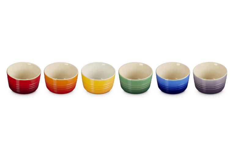 Set of six Le Creuset ramekins in red, orange, yellow, green, blue, and purple, shown from above.