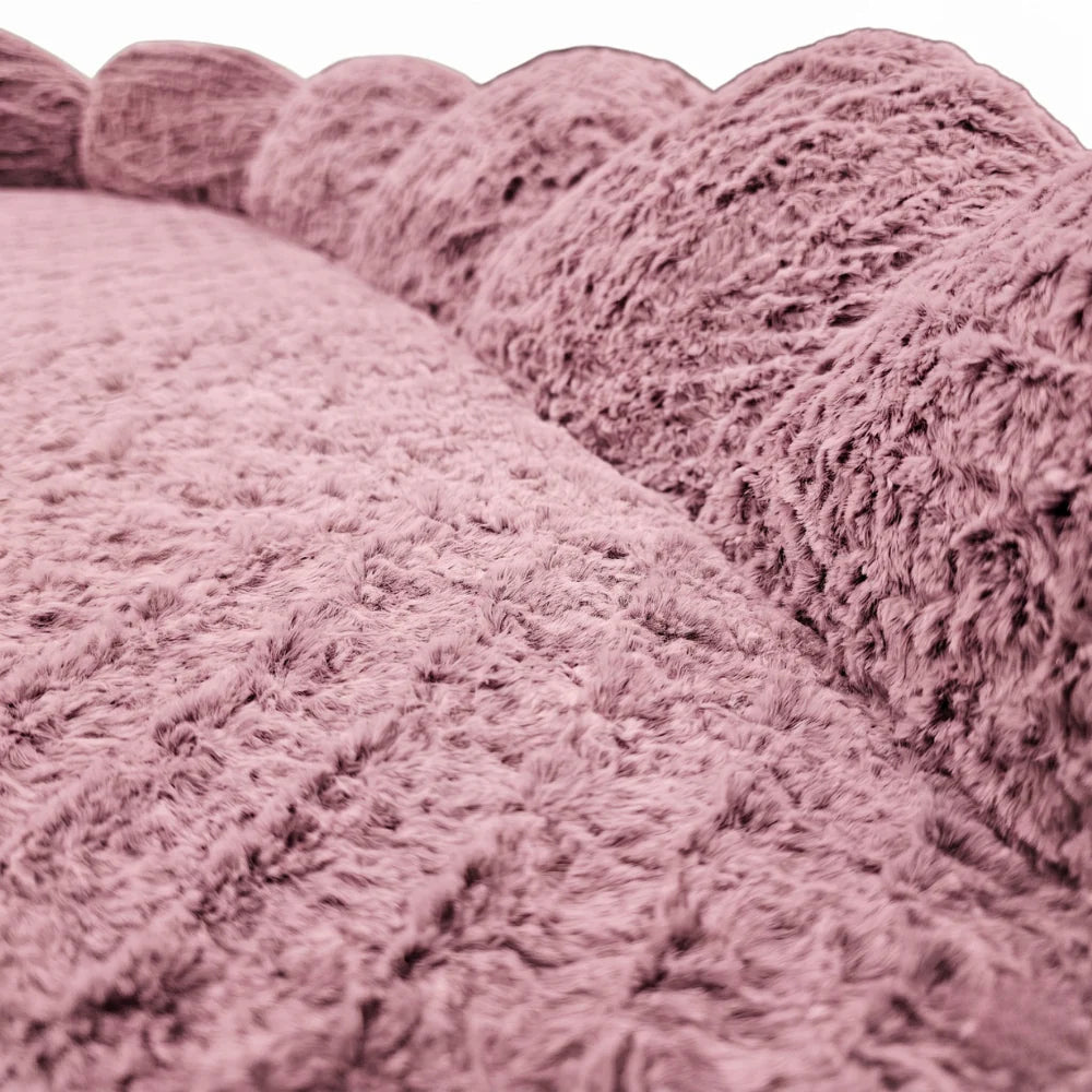 Close-up of the soft, textured pink fabric and scalloped edge of the Alice & Co Beverley Bed.