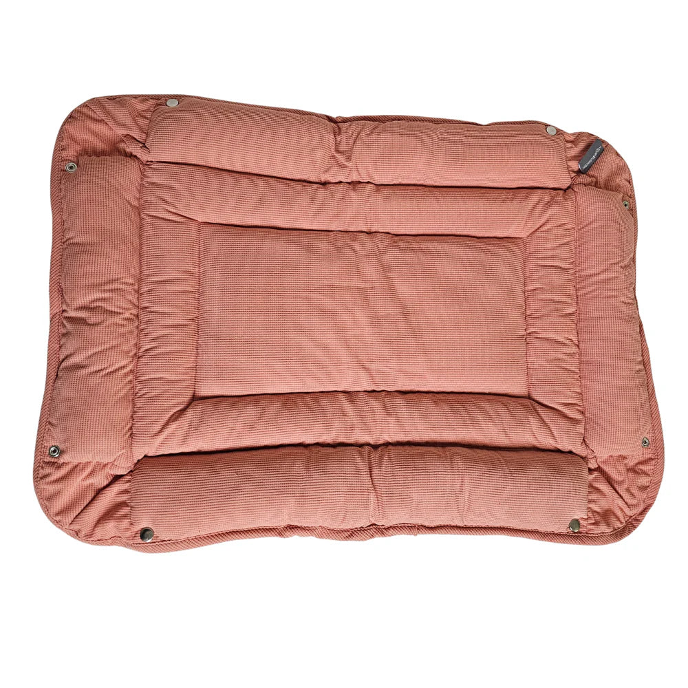 Wiggle & Wander pet mat bed in pink with padded edges and textured fabric, shown flat from above.