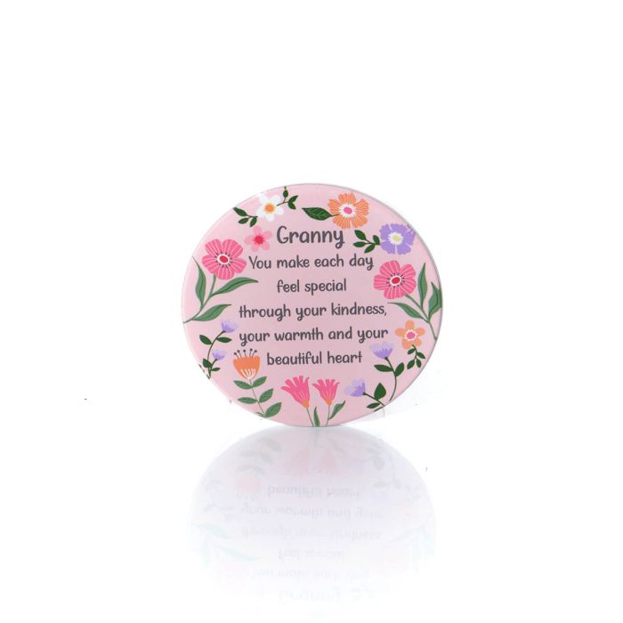 Round pink ceramic coaster with floral border and message for Granny about kindness and warmth.