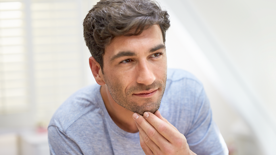 Philips Multigroom Series 3000 grooming kit shown trimming facial hair on a man’s chin