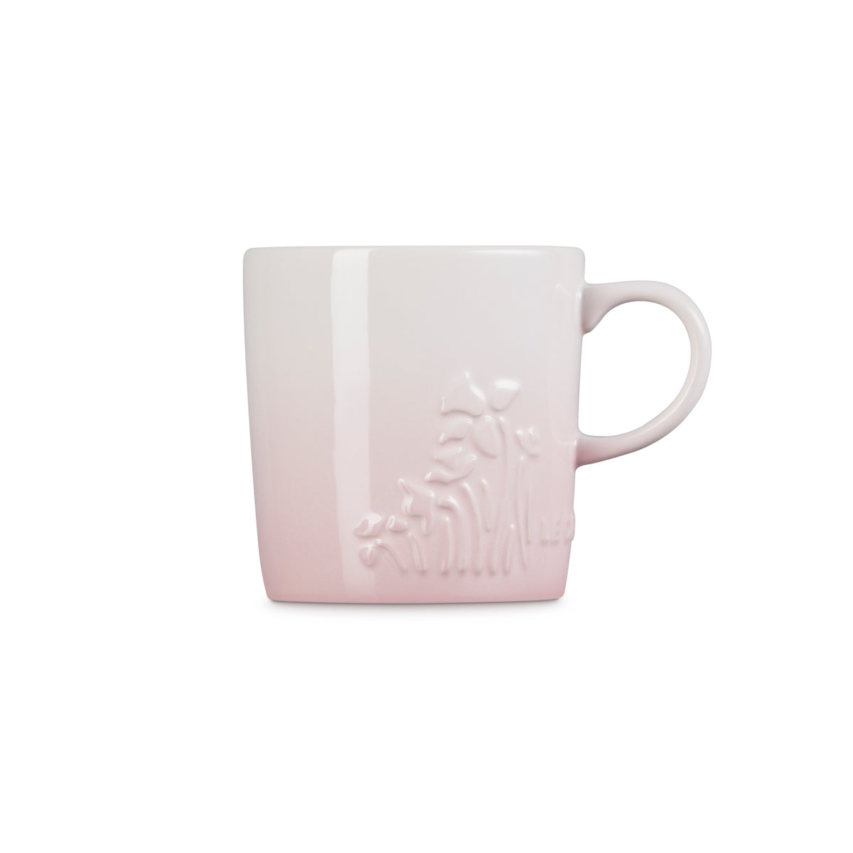 Le Creuset London Mug in shell pink with embossed floral design and side handle on white background