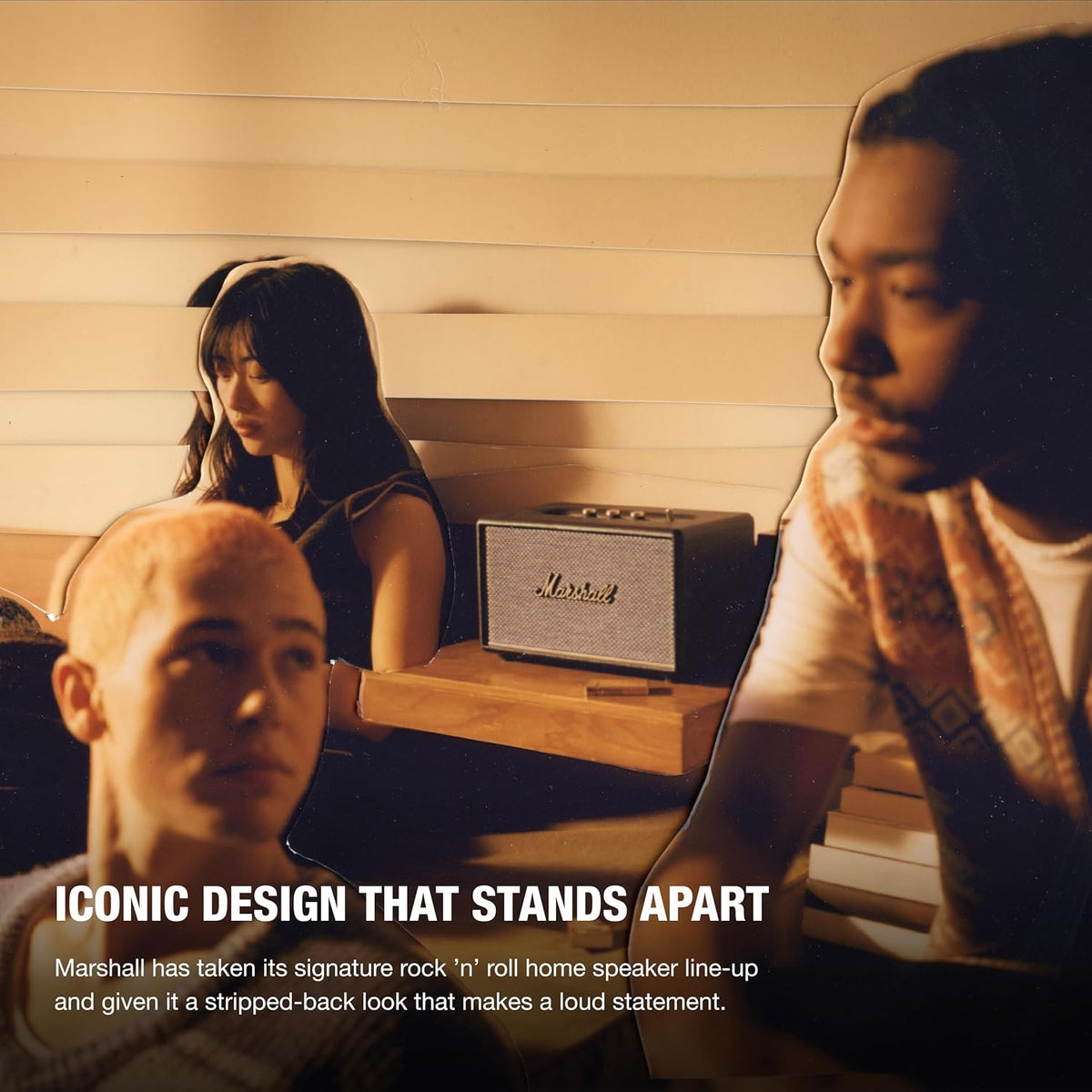 Marshall Acton III Bluetooth speaker in black on a wooden shelf with three people nearby in warm lighting