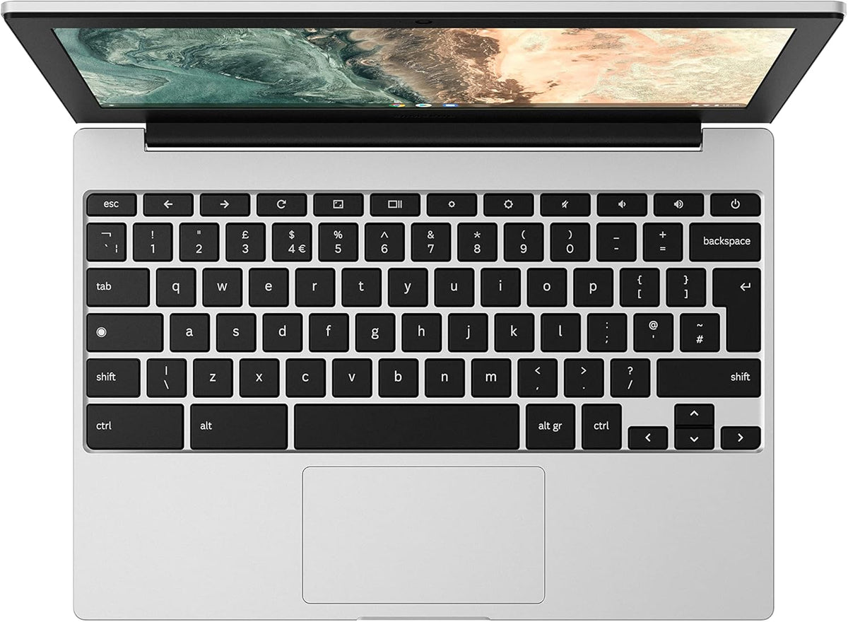 Samsung Chromebook Go 11.6 inch silver laptop keyboard and touchpad with screen partially open showing desktop background.