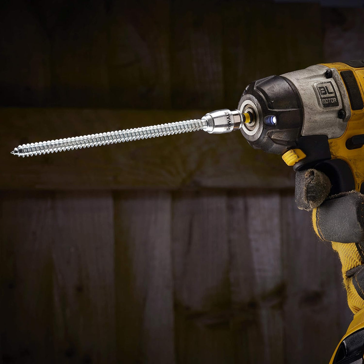 DeWalt impact driver with magnetic screwlock sleeve and long silver screw bit attached