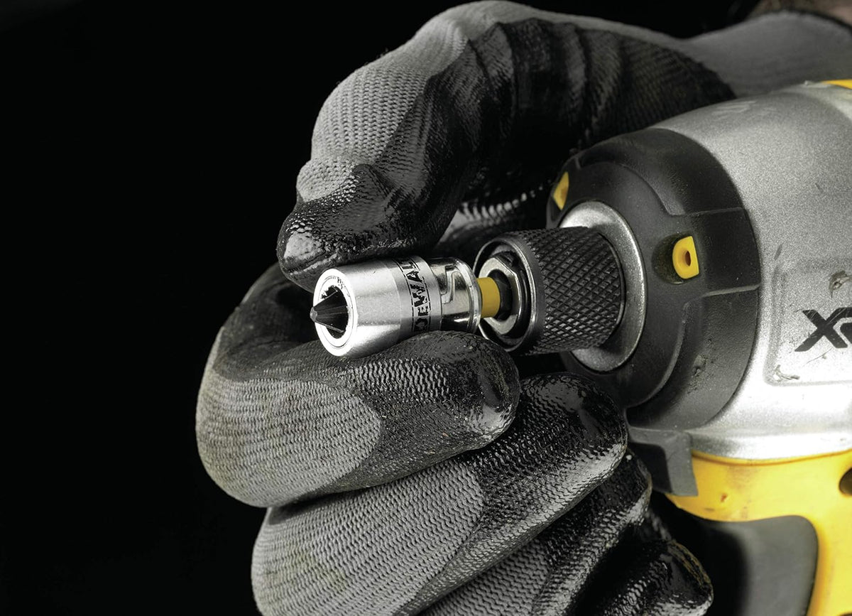 Gloved hand attaching DeWalt Impact Torsion bit and magnetic screwlock sleeve to drill chuck.